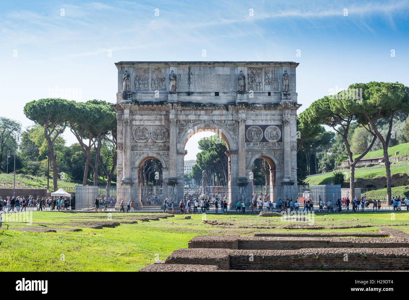 Constantine Arch old roman architecture monument in sunny day and tourists walking around Stock Photo