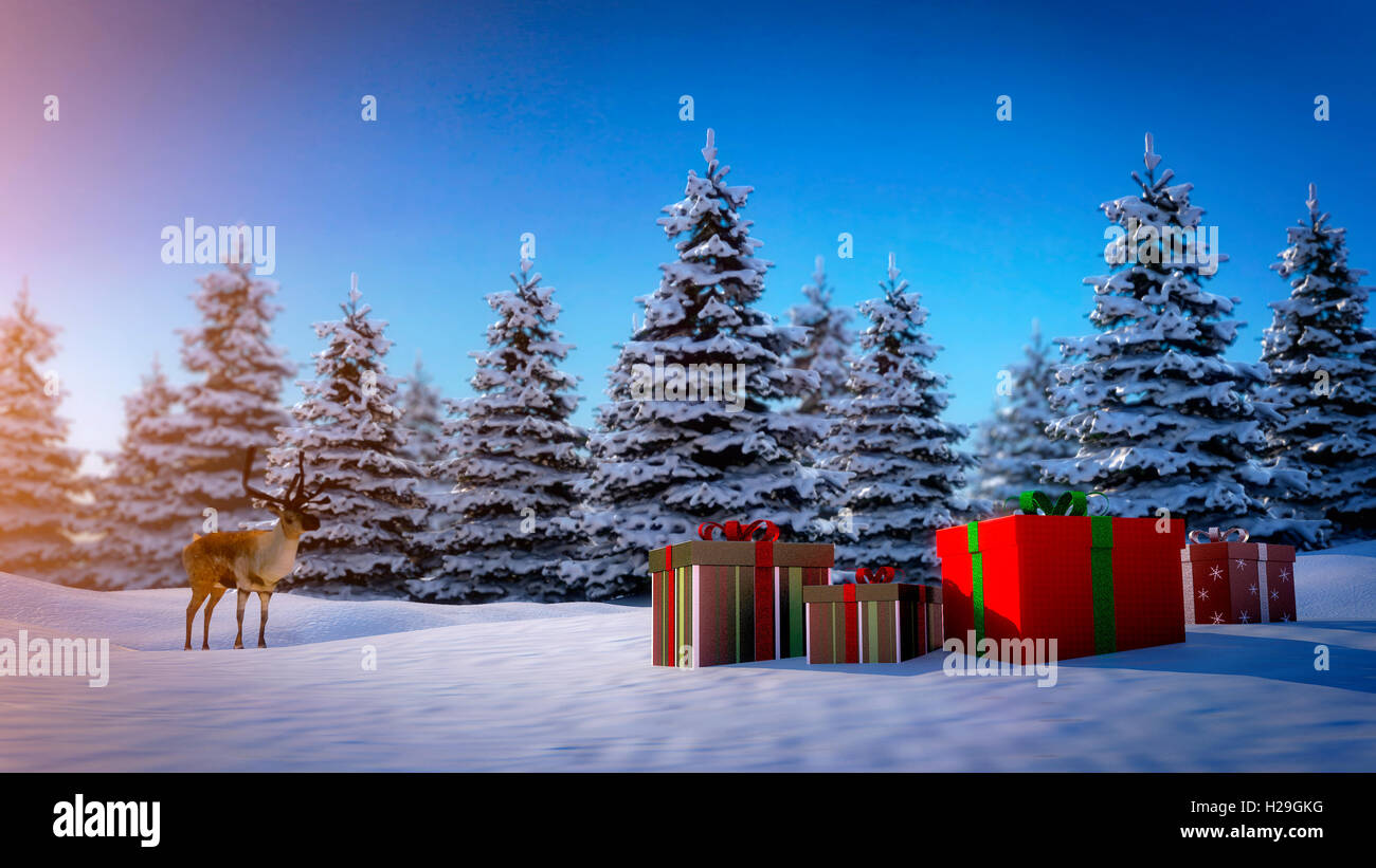 reindeer looks at christmas gift boxes on snowy ground with pine trees in background. Stock Photo