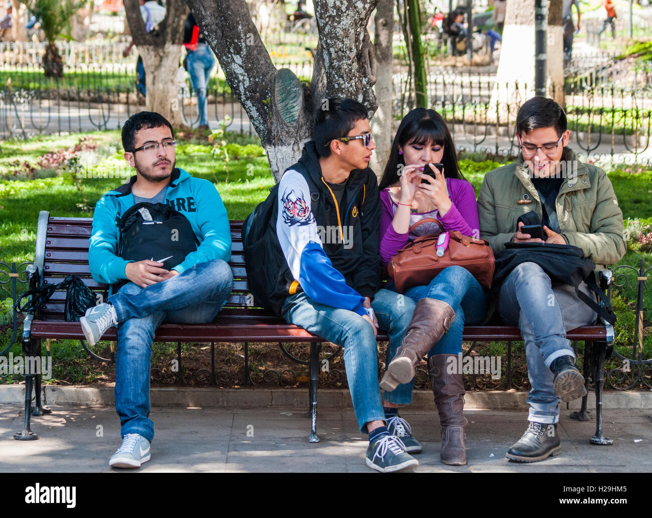Students take time out in the city centre Plaza 25 de Mayo, Sucre, Bolivia Stock Photo