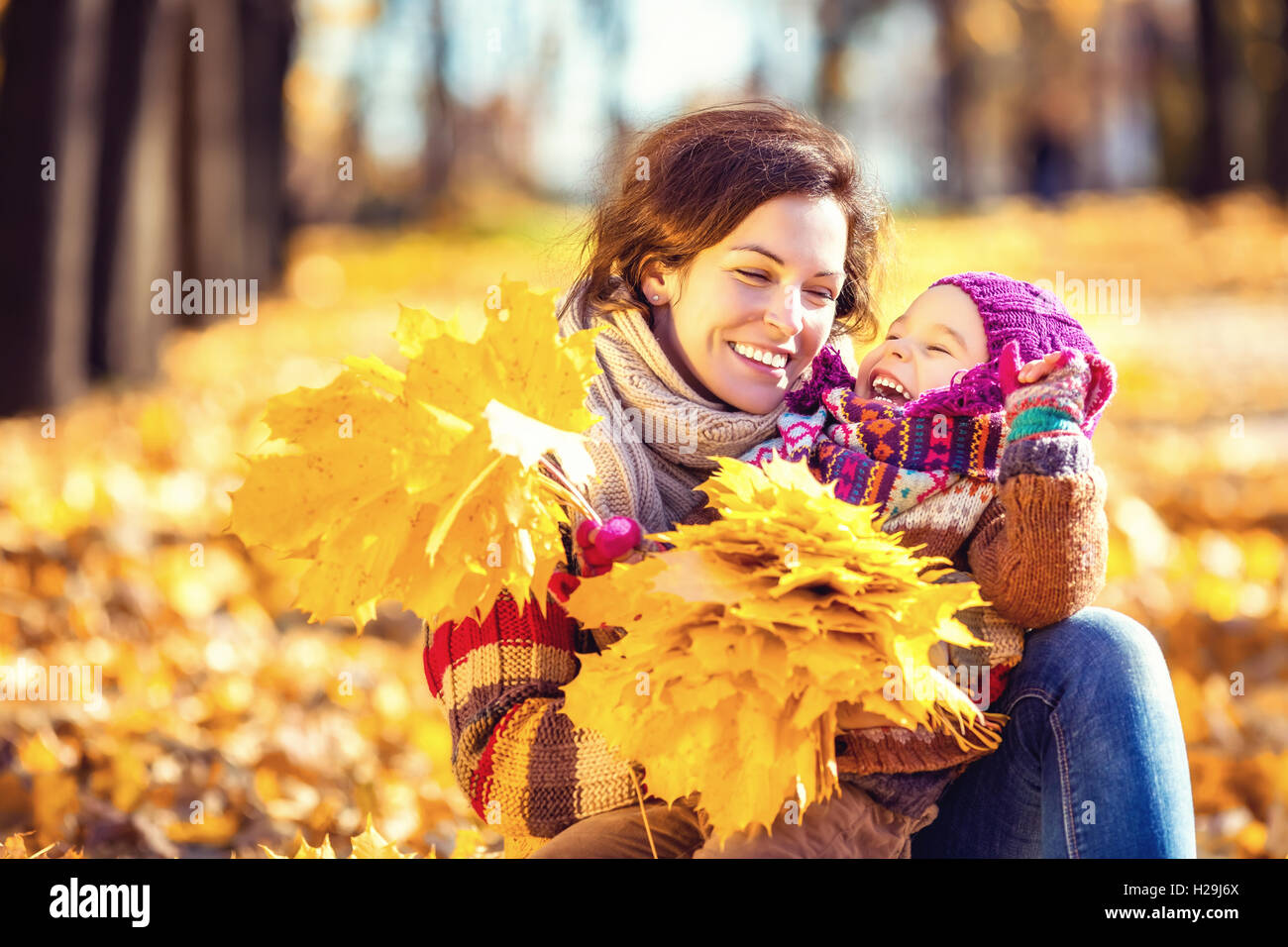 Mother and daughter playing in autumn park Stock Photo - Alamy