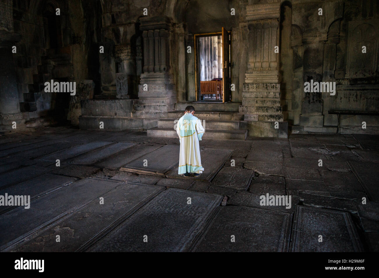 A boy preparing for the service at Haghpat monastery in Armenia Stock Photo