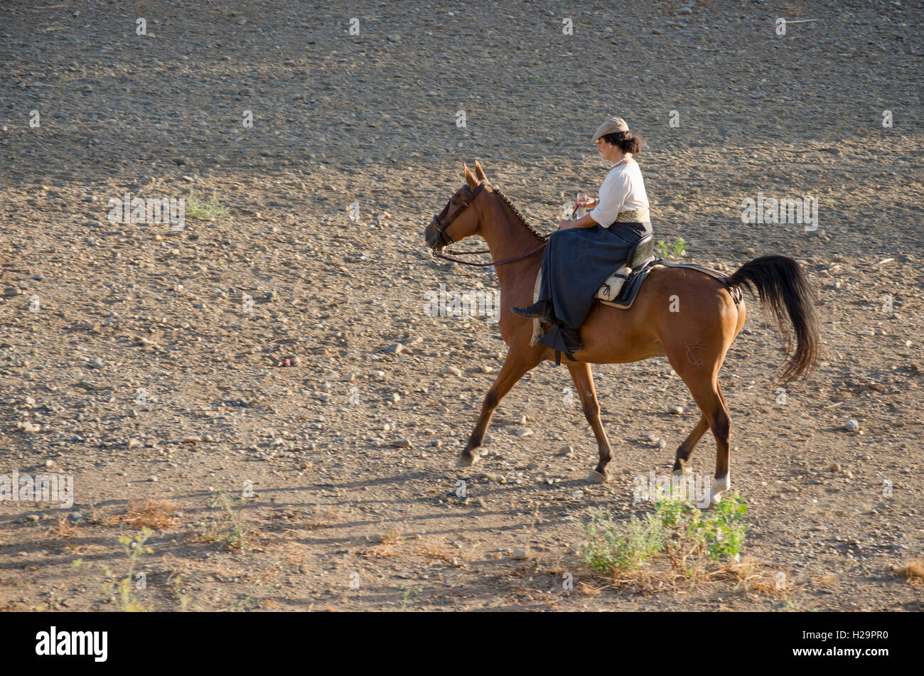 Girl on horse in traditional flamenco dress at Romeria of Fuengirola, religious pilgrimage one week before the annual fair, Fuengirola, Andalusia, Spain. 25 september, 2016.  Feria Credit:  Perry van Munster/ Alamy Live News Stock Photo