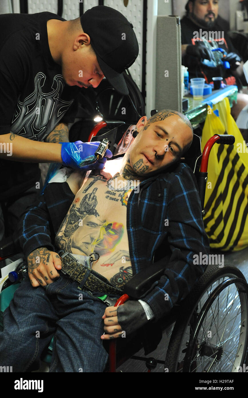 London, UK. 25th Sep, 2016. A disabled man getting a tattoo at the 12th London International Tattoo Convention, which took place in Tobacco Dock, east London over the weekend. The show featured over 400 of the world's finest, most prestigious and elite tattoo artists as well as a showcasing alternative culture in the form of piercing, burlesque and the Miss Pin Up UK competition. Around 20,000 people attended over the weekend. Credit:  Michael Preston/Alamy Live News Stock Photo