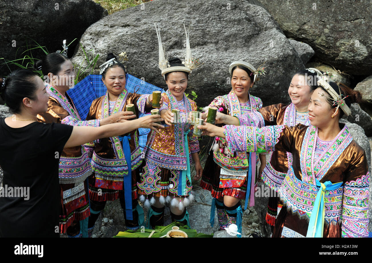 Nanning, China's Guangxi Zhuang Autonomous Region. 24th Sep, 2016. A visitor (1st L) toasts with villagers during a local festival in Wuji Village under Anchui Township of Miao Autonomous County of Rongshui, south China's Guangxi Zhuang Autonomous Region, Sept. 24, 2016. Activities including catching fish, fishing feast and dancing will be held during the festival. © Li Bin/Xinhua/Alamy Live News Stock Photo