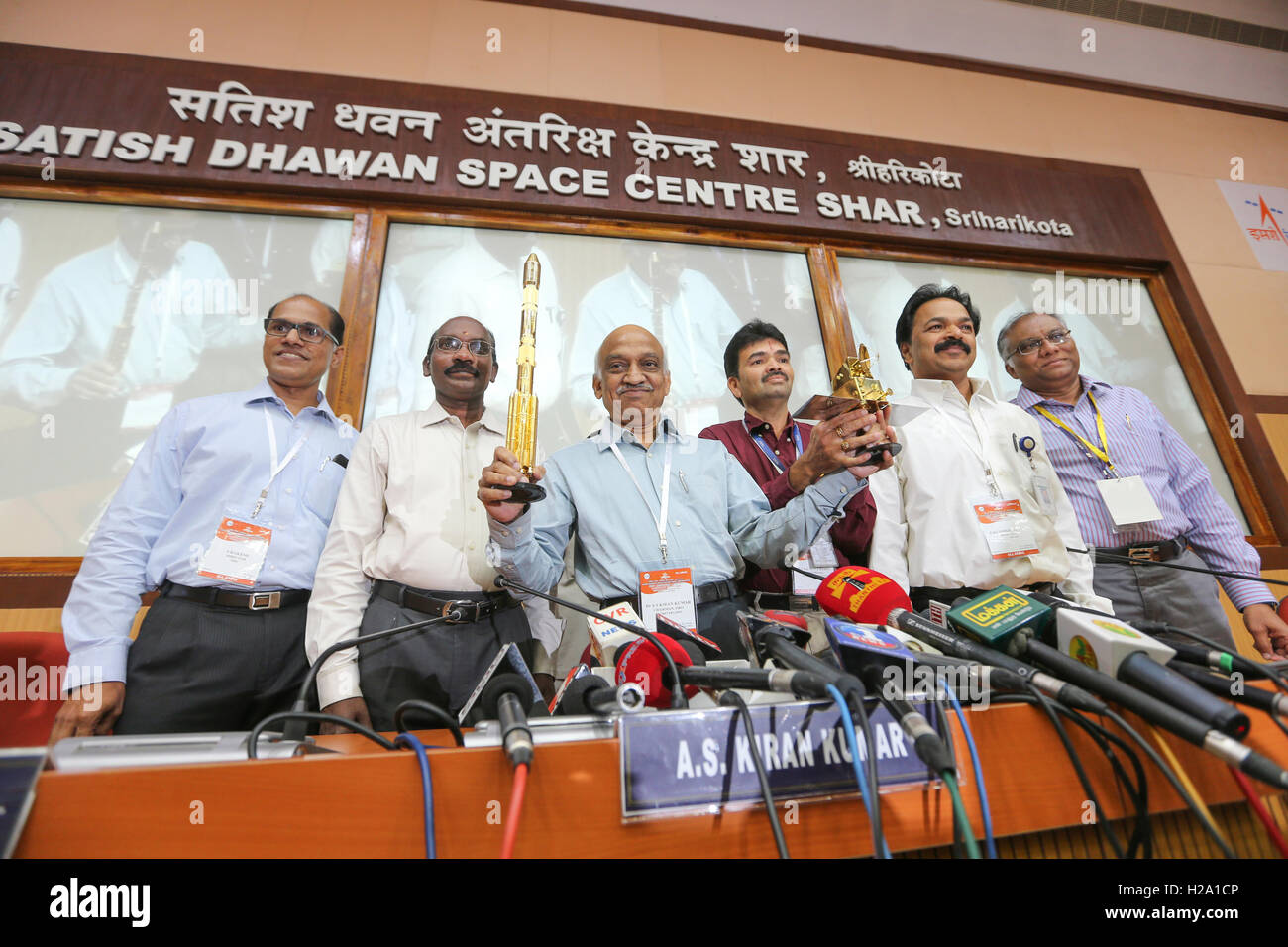 Sriharikota, Andrapradesh, India. 26th September, 2016. Dr. A.S. Kiran Kumar holding the miniature Rocket and the SCATSAT-1 on his hands PSLV C-35, carrying India's SCATSAT-1 meant for ocean and after successfully lifted off from the spaceport meant for weather studies and seven other satellites including from the US and Canada, Credit:  SUKUMAR S/Alamy Live News Stock Photo