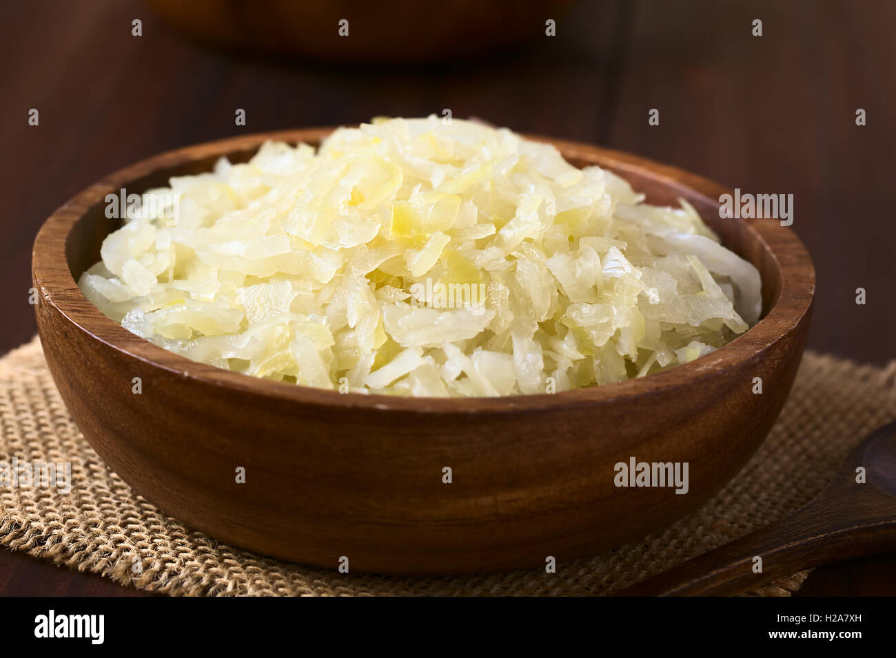 Sauerkraut in wooden bowl, photographed with natural light (Selective
