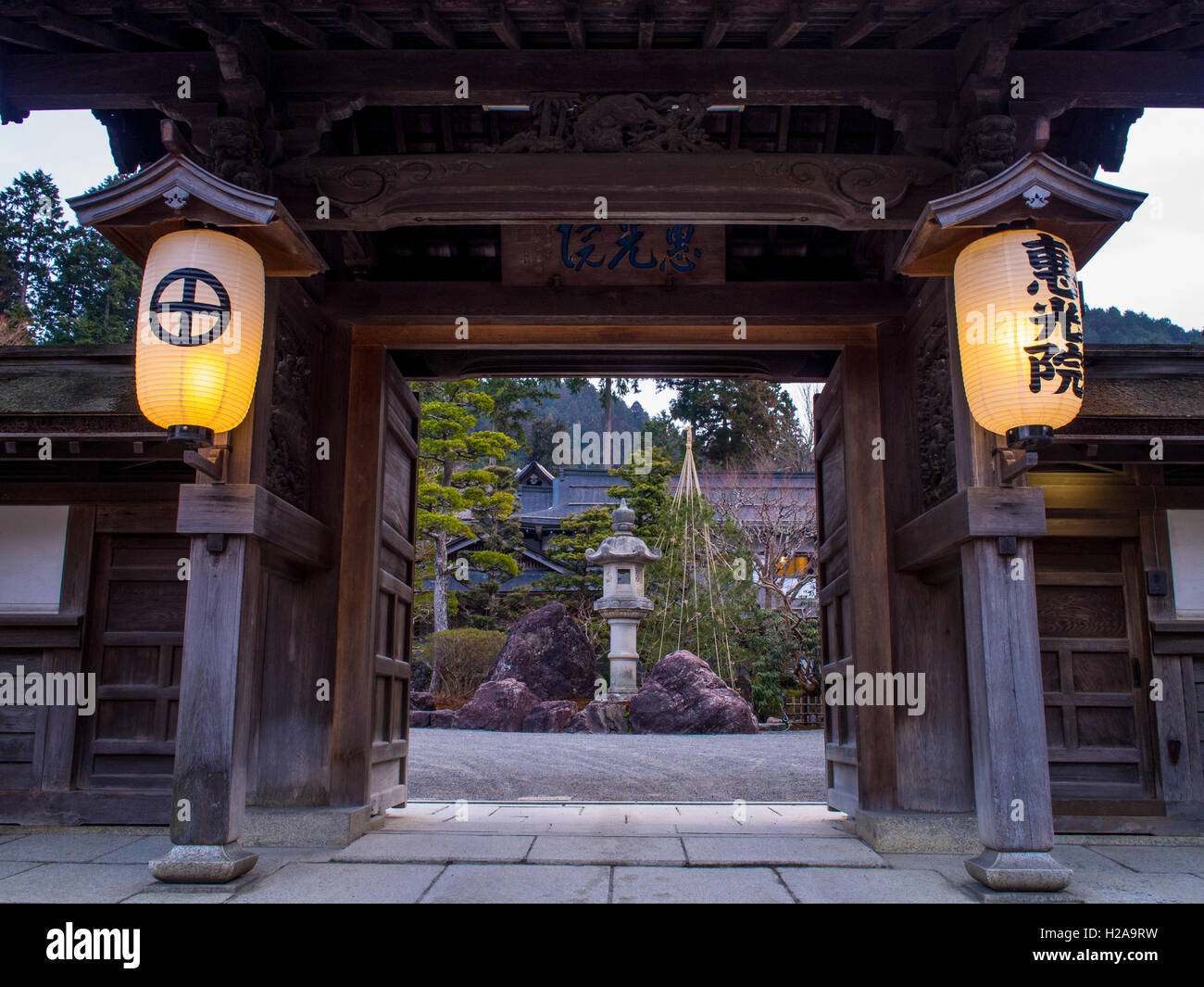 Temple Gate,  Ekoin,  Koyasan,  Wakayama Japan. Chochin lanterns with bold kanji characters framing view of stone lantern garden Stock Photo