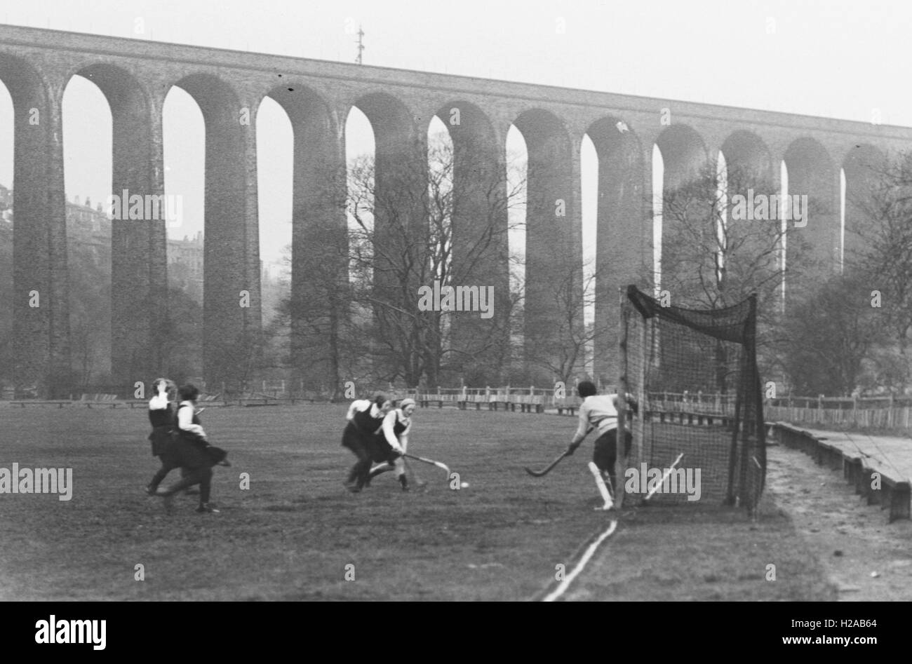 Ladies Hockey Team playing a match with Lockwood Viaduct in the background, Huddersfield 1931. Photo by Tony Henshaw Stock Photo