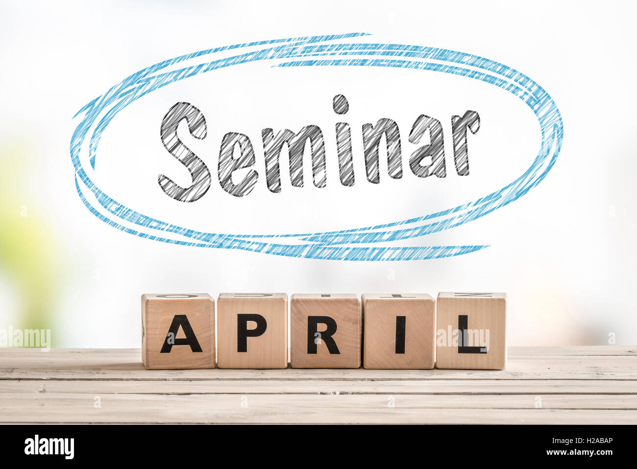 Seminar in april launch sign made of wooden cubes Stock Photo