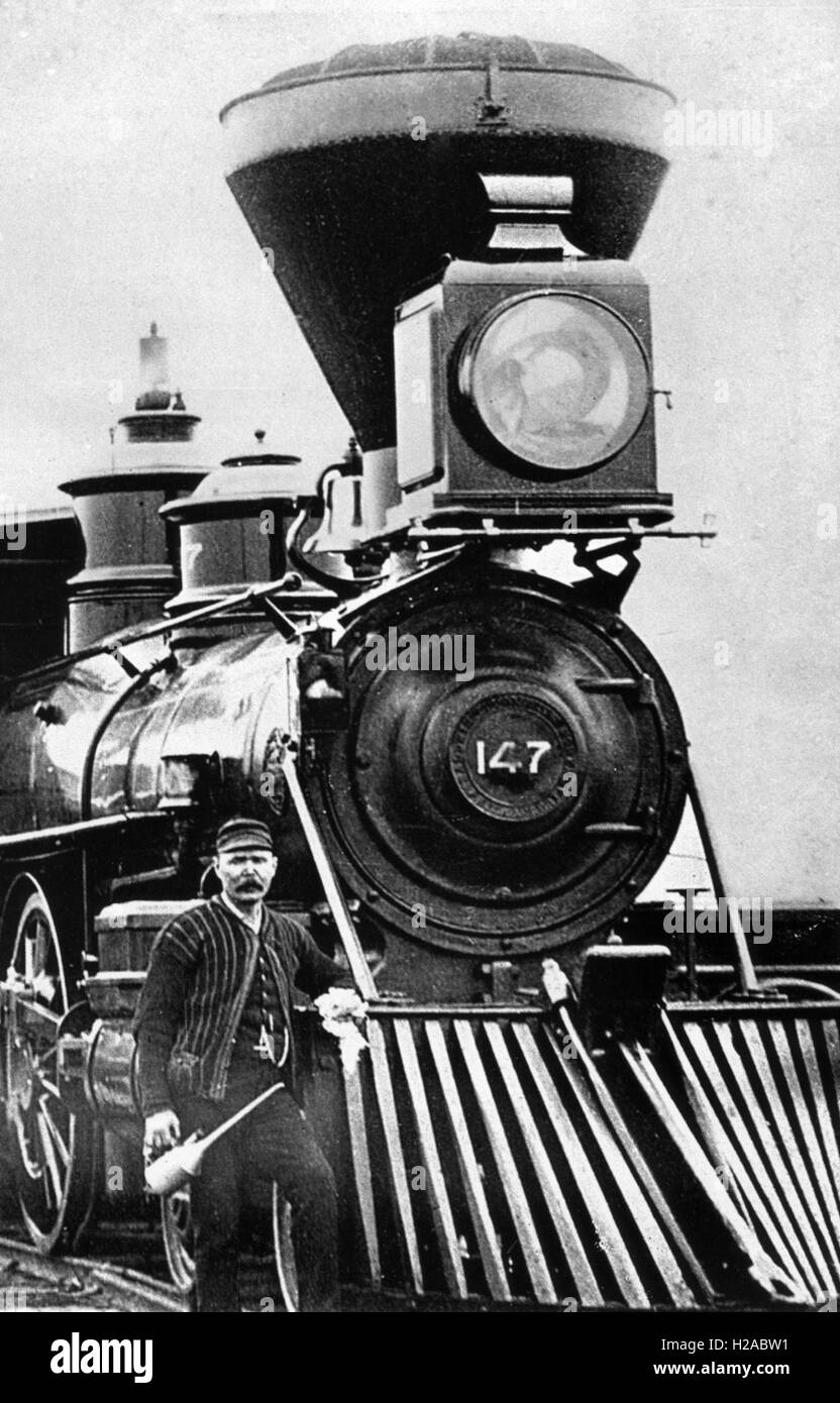 AMERICAN CENTRAL PACIFIC STEAM LOCOMOTIVE number 147 with cow catcher guard and engineer with grease gun about 1880 Stock Photo