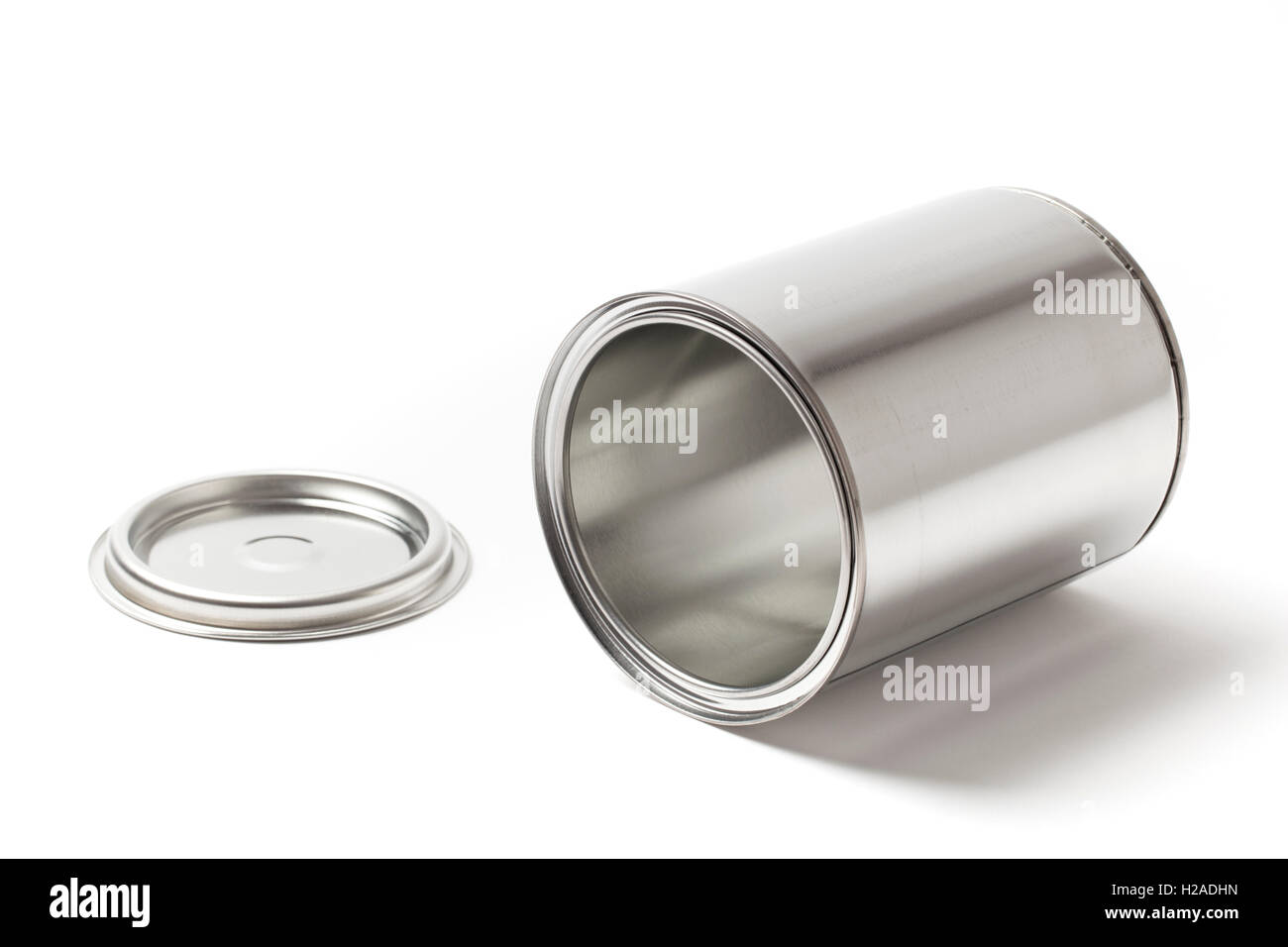 Open blank metallic paint can lying and isolated on a white background. Stock Photo