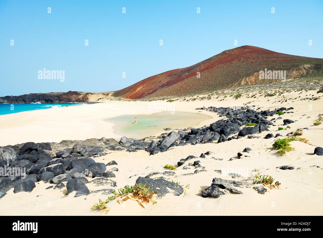 Lanzarote, Canary Islands. Along beach of Playa de las Conchas on Isla Graciosa, Lanzarote, to volcanic cone of Montana Bermeja Stock Photo