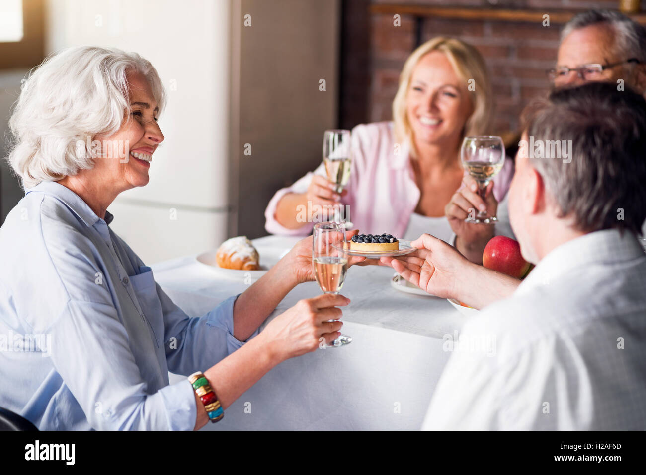 Friends and family celebrating wedding anniversary of nice old couple Stock Photo