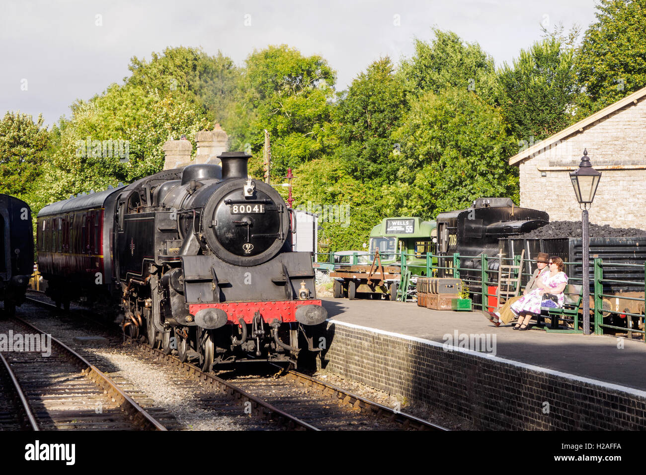 Steam train hauled by ex-BR Class 4 tank locomotive standing at Midsomer Norton station HQ of the S&D Jt Rly Trust. Stock Photo