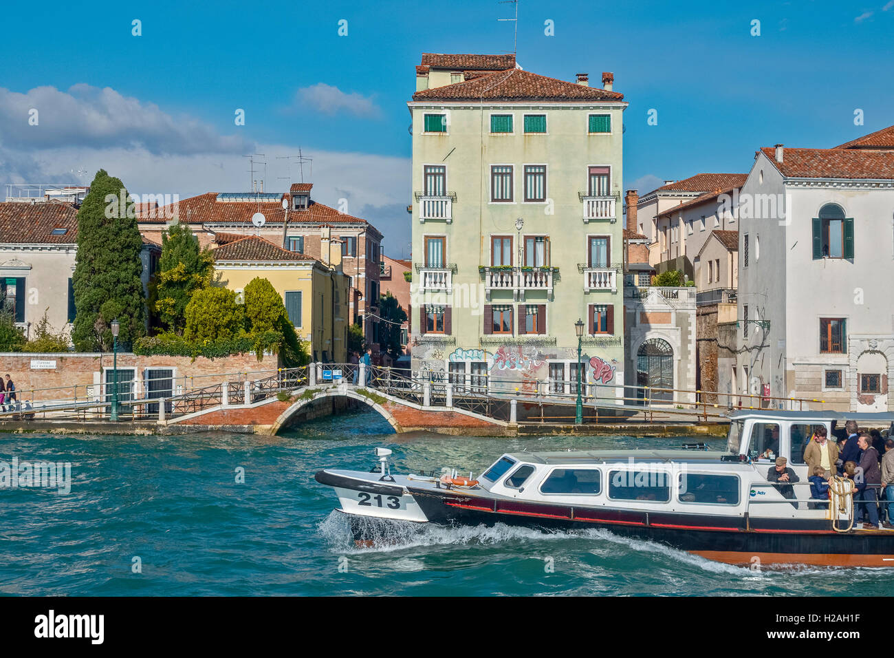 Boat Passing A Bridge Over A Canal Venice Italy Stock Photo