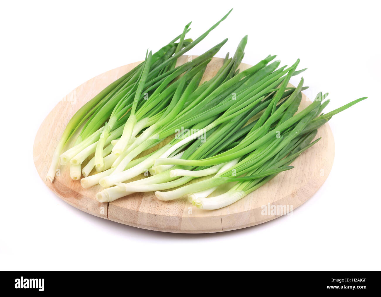 Bunch of green onion on wooden platter Stock Photo - Alamy