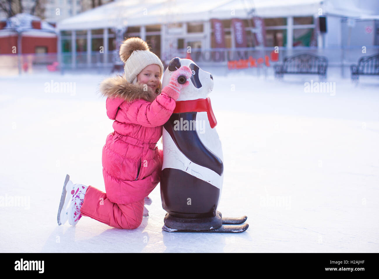 Little happy girl skating on the icerink Stock Photo Alamy