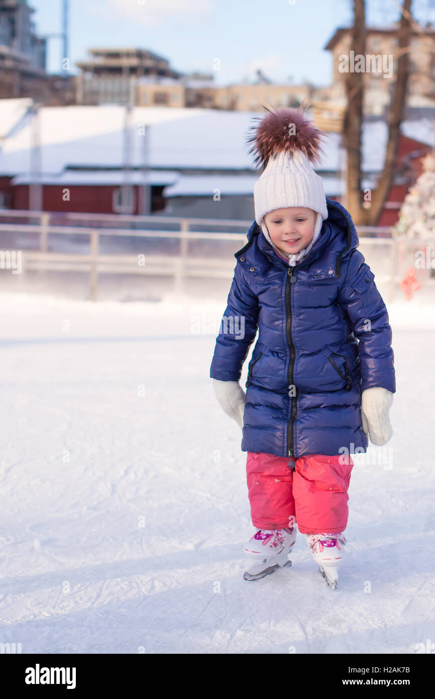 Adorable little girl in the skate on white ice Stock Photo Alamy