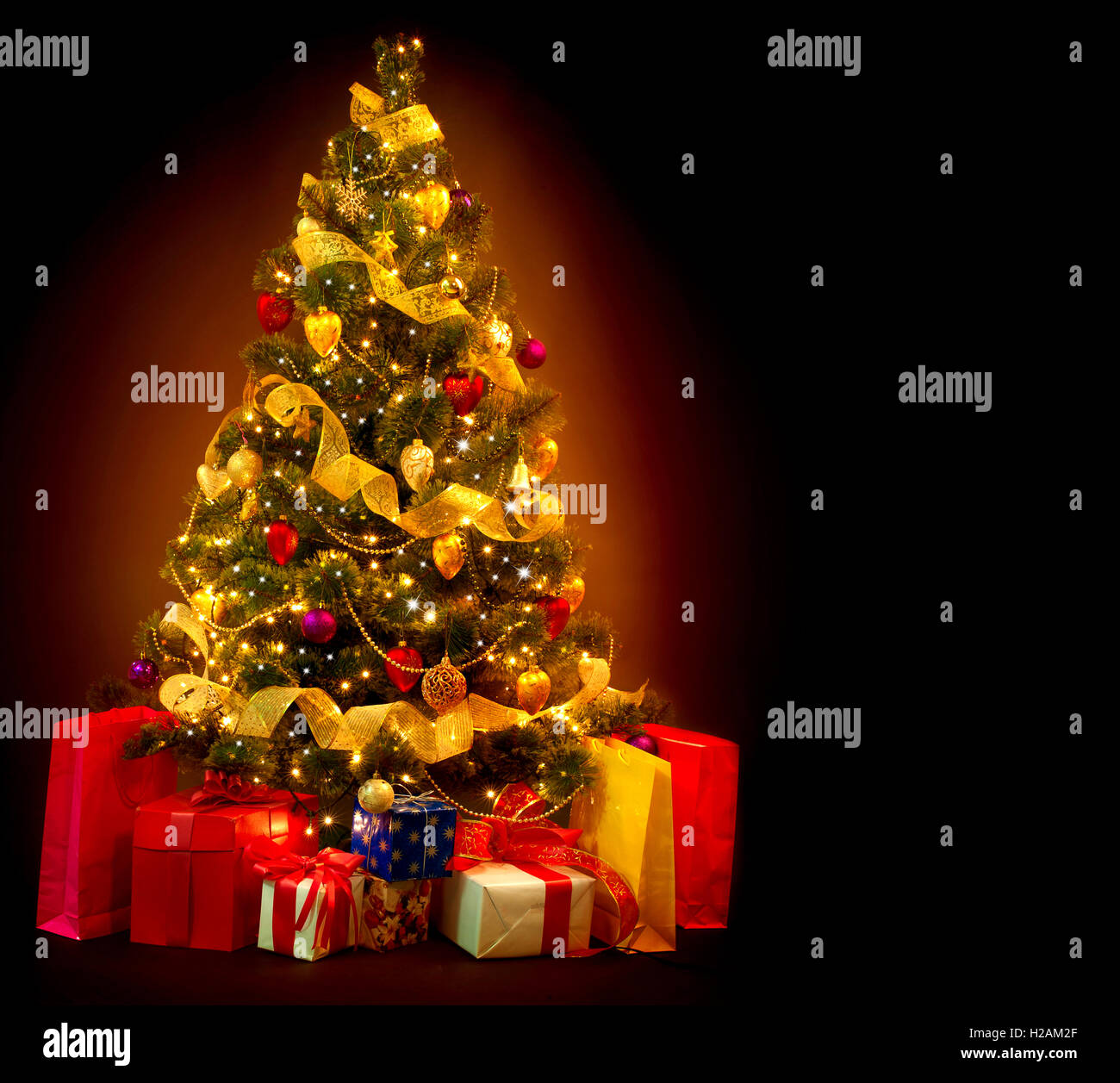 Christmas Tree with Gifts isolated on black background Stock Photo - Alamy