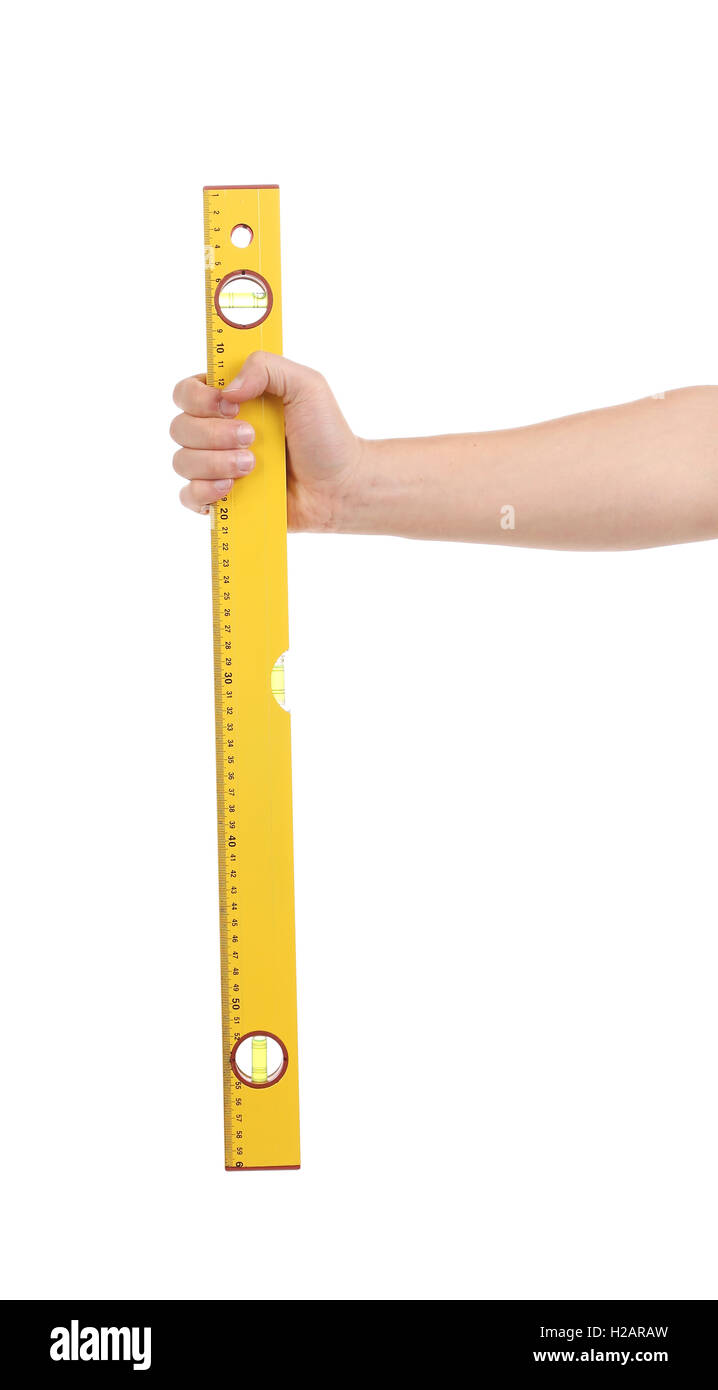 Yellow building level in hand Stock Photo - Alamy