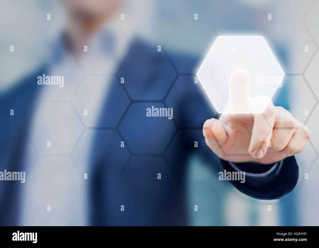 Person touching an hexagonal button on a digital interface. Concept about technology and choices Stock Photo