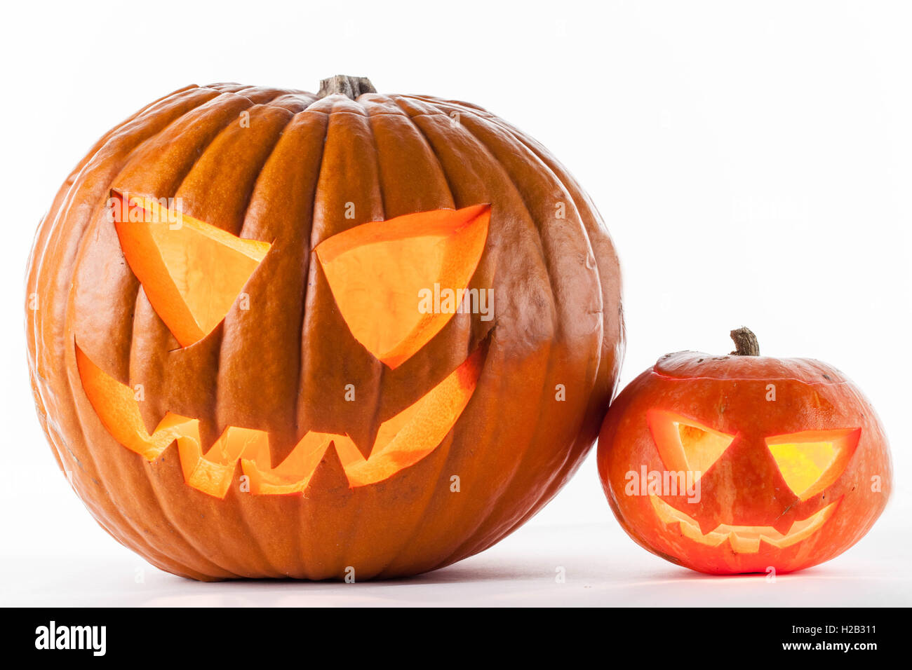 Glowing Halloween pumpkins isolated on white background Stock Photo - Alamy