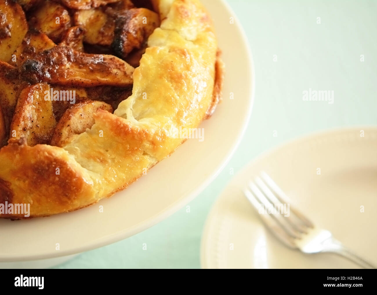 Fresh home made apple galette right from the oven on cake stand in horizontal format Stock Photo