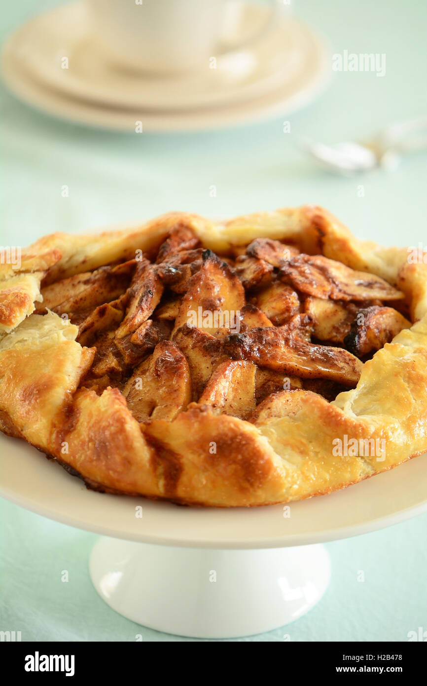 Fresh home made apple galette right from the oven on cake stand in vertical format Stock Photo