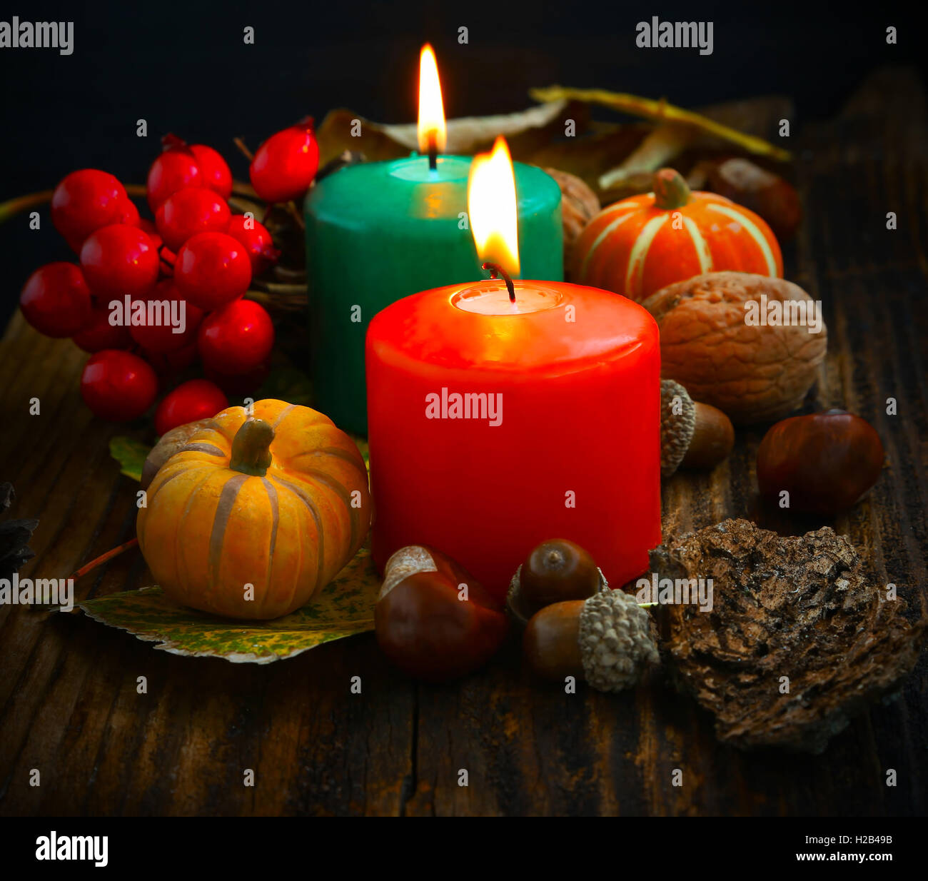 Decorative autumn candles burning with pumpkins and fall decorations ...