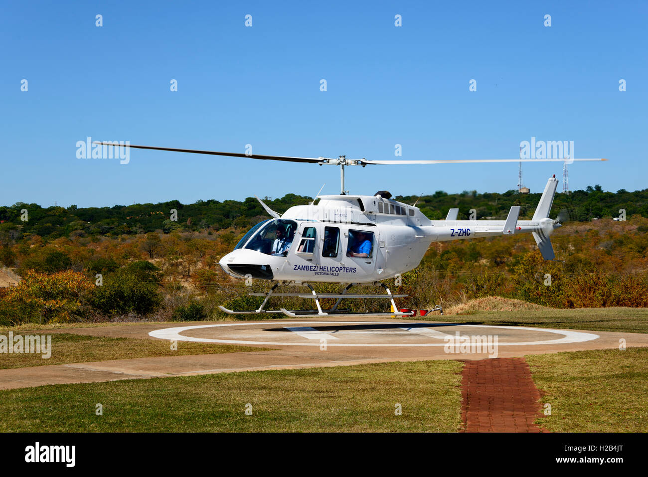 Helicopter on landing pad, takeoff, Zambezi Helicopters, Z-ZHC, Zimbabwe Stock Photo