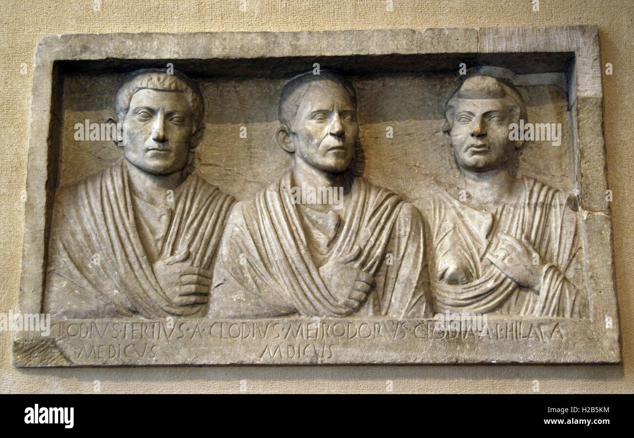 Roman Art. Funerary portrait. Marble. Relief from a tomb. It shows three family members From left: Clodius Tertius (the son), Clodius Metrodorus (the father) and, on the right, Clodia Hilara (presumably wife/mother). The term 'medicus' is refered to the profession of the two men. Last third of the 1st century B.C. Villa Taverna in Frascati belonging to the family of the Borghese princes. Louvre Museum. Paris. France. Stock Photo