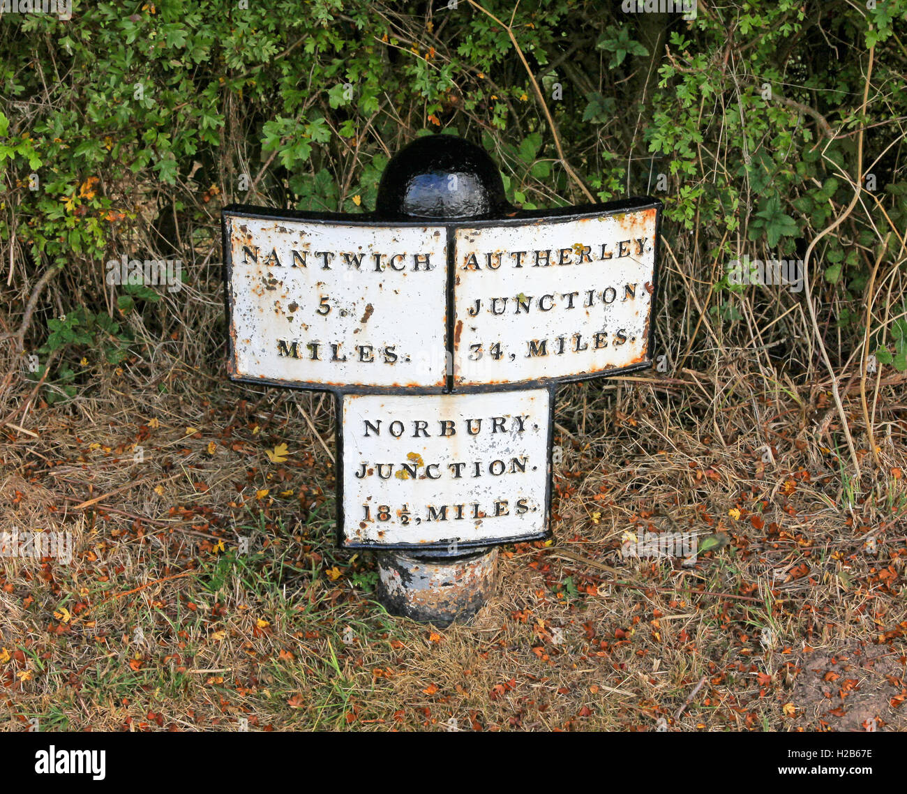 A milepost saying Nantwich, Autherly Junction and Norbury Junction on the Shropshire Union Canal Cheshire England  UK Stock Photo