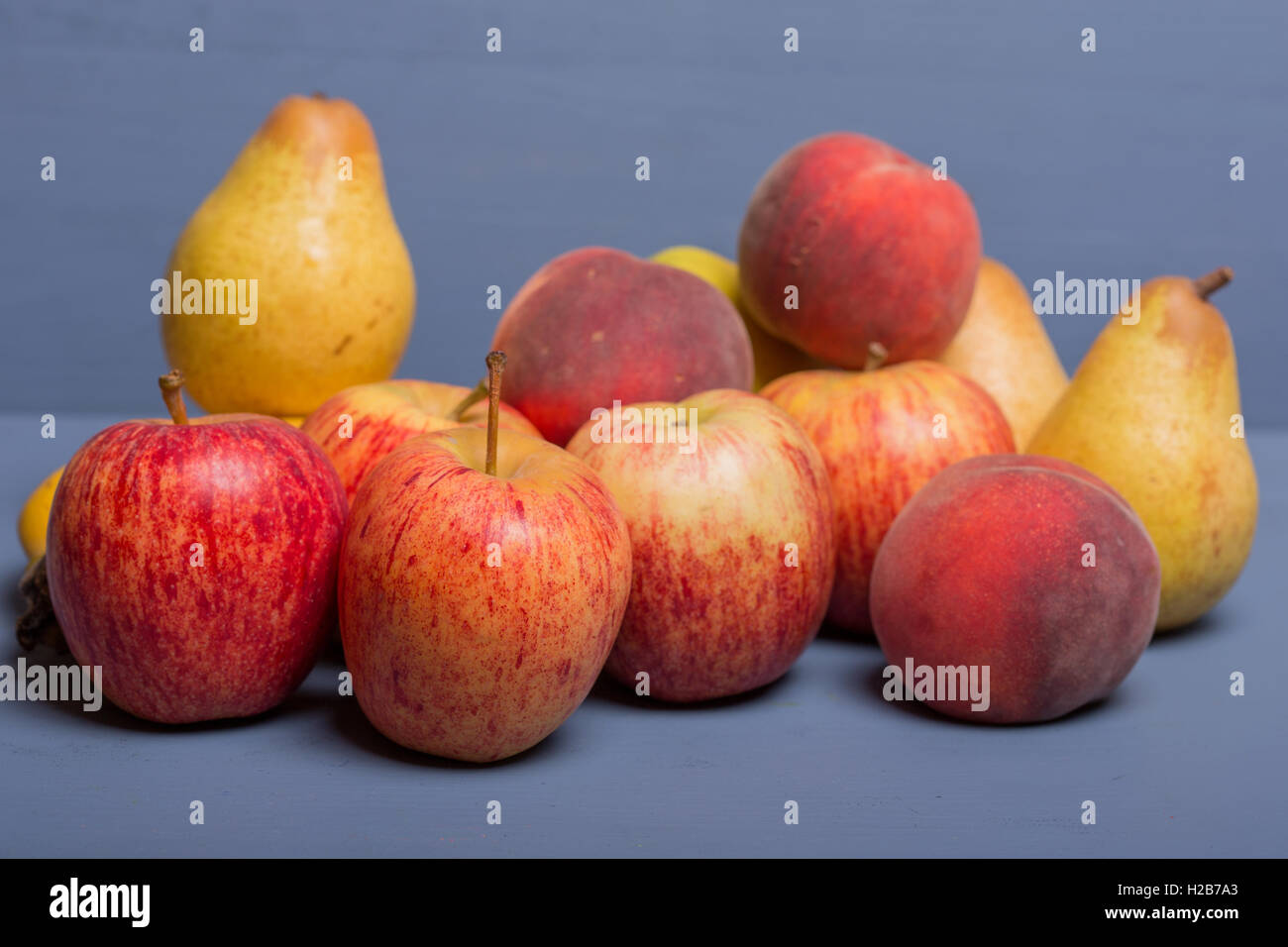 fruits on a blue wooden table, studio picture Stock Photo - Alamy