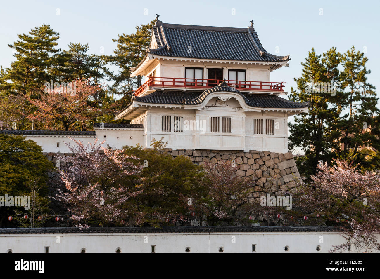 Fukuyama castle in Japan. The corner two story Tsukimi yagura, or 'moon-viewing' turret, located on the inner castle wall. Golden hour. Stock Photo