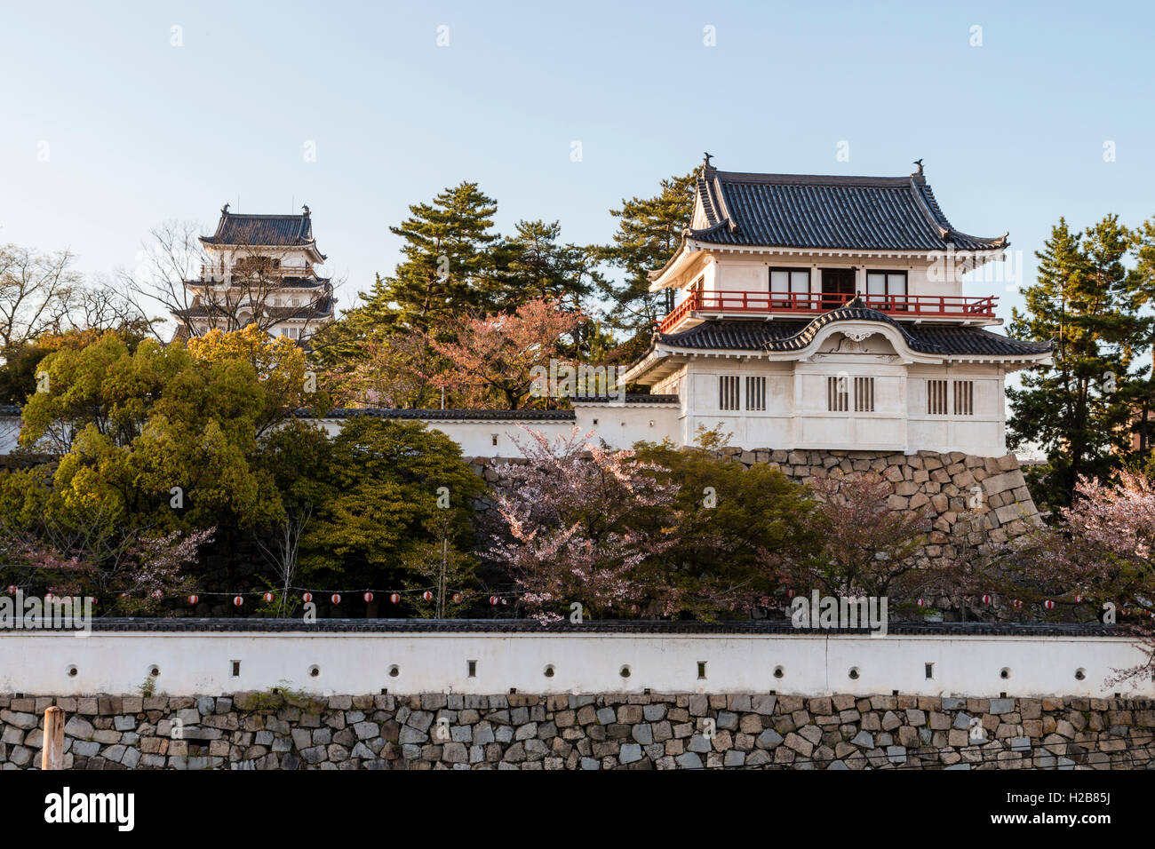 Fukuyama castle in Japan. The corner two story Tsukimi yagura, or 'moon-viewing' turret, located on the inner castle wall. Golden hour. Stock Photo