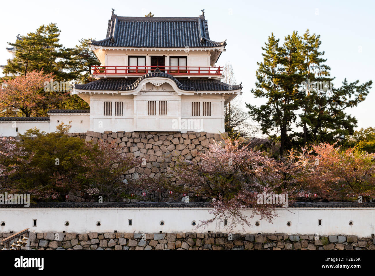 Fukuyama castle in Japan. The corner two story Tsukimi yagura, or 'moon-viewing' turret, located on the inner castle wall. Golden hour. Stock Photo