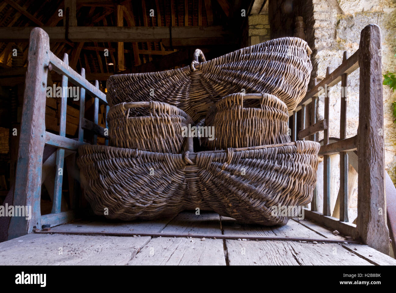 Traditional Burgundian harvest wicker baskets stacked on old wooden cart in  cellar Beaune, Côte d'Or, France Stock Photo - Alamy
