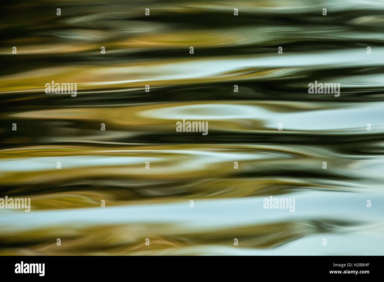 Waves in a river at sunset as another boat went by, in Pantanal area of Brazil. Stock Photo