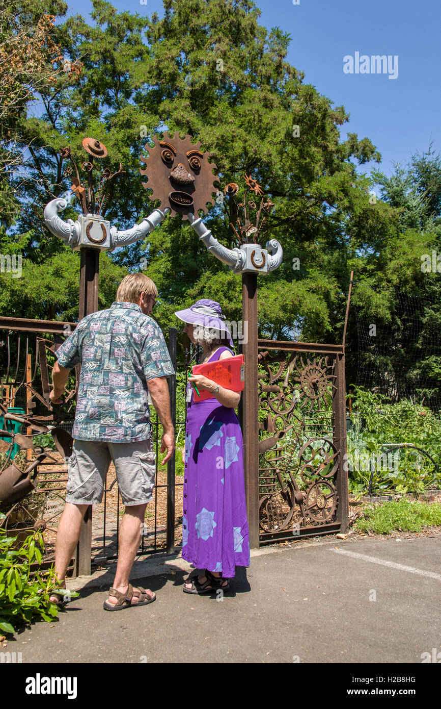 Couple entering the Issaquah Flatland Community Garden in Issaquah, Washington, USA. Stock Photo