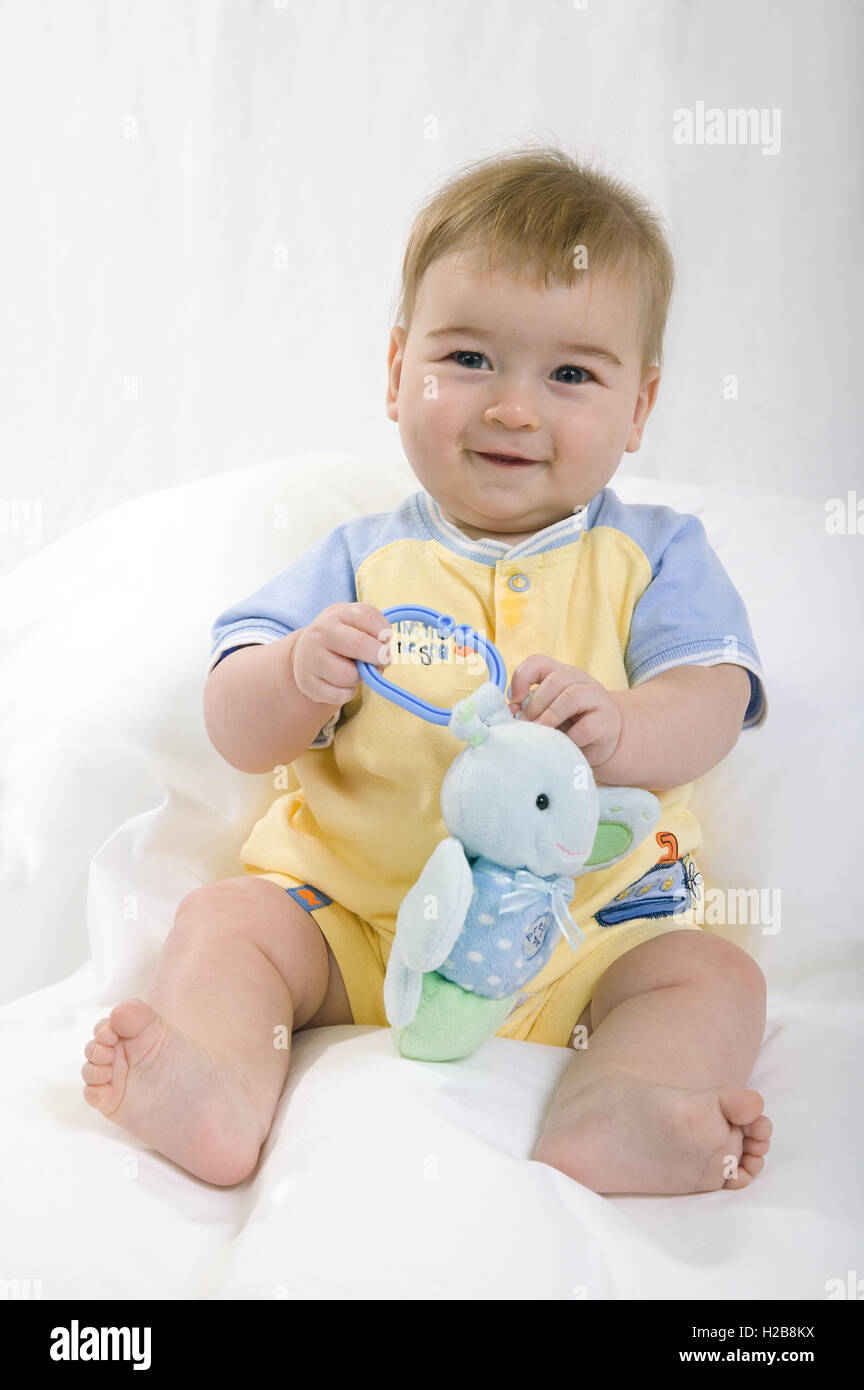 Seven month old baby boy playing with a toy Stock Photo Alamy