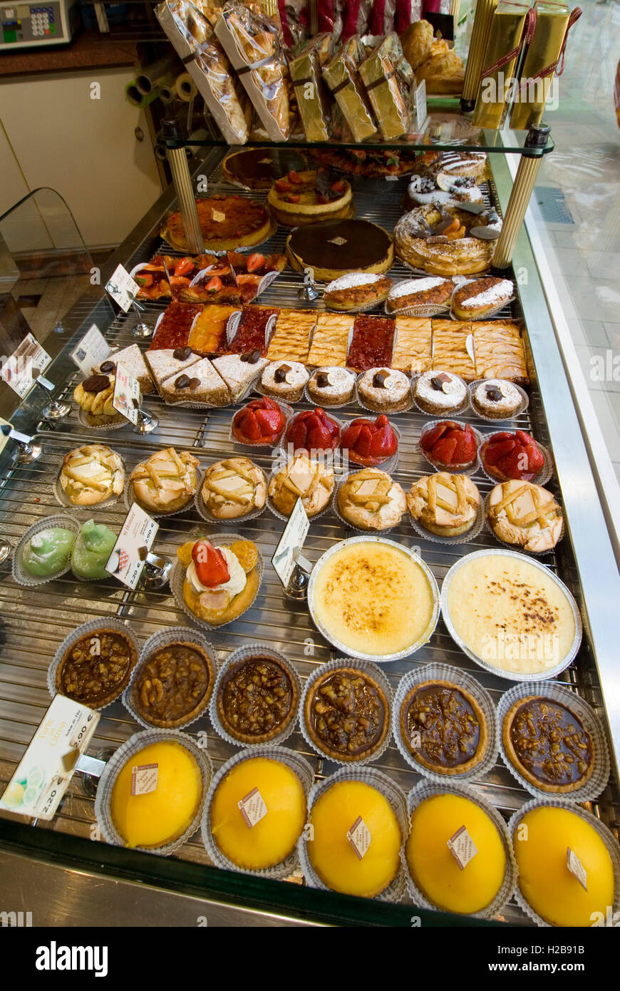 Patisserie window display with variety of fine cakes and pastries Beaune Burgundy France Stock Photo