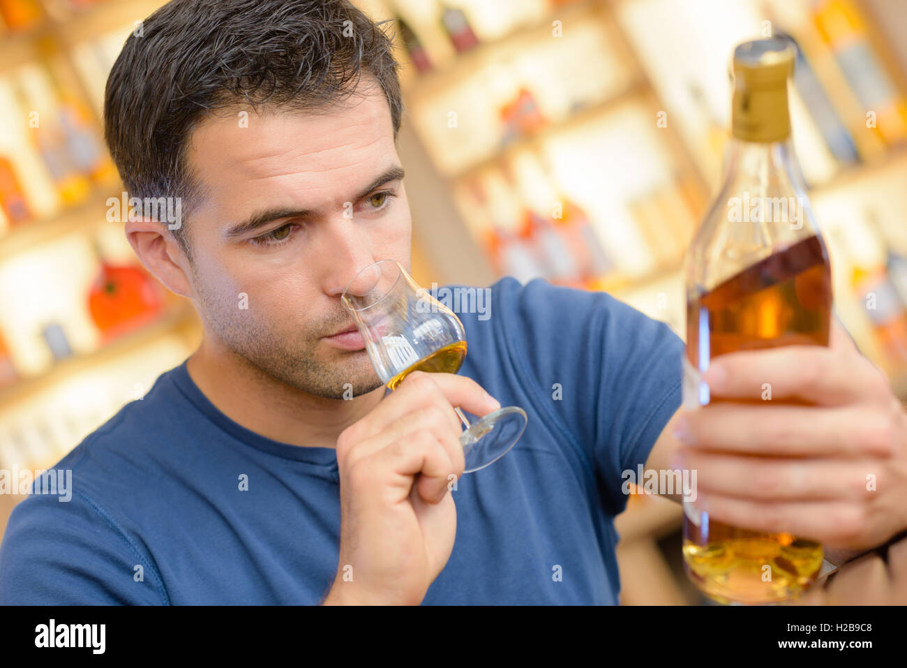 man reading the alcohol label Stock Photo