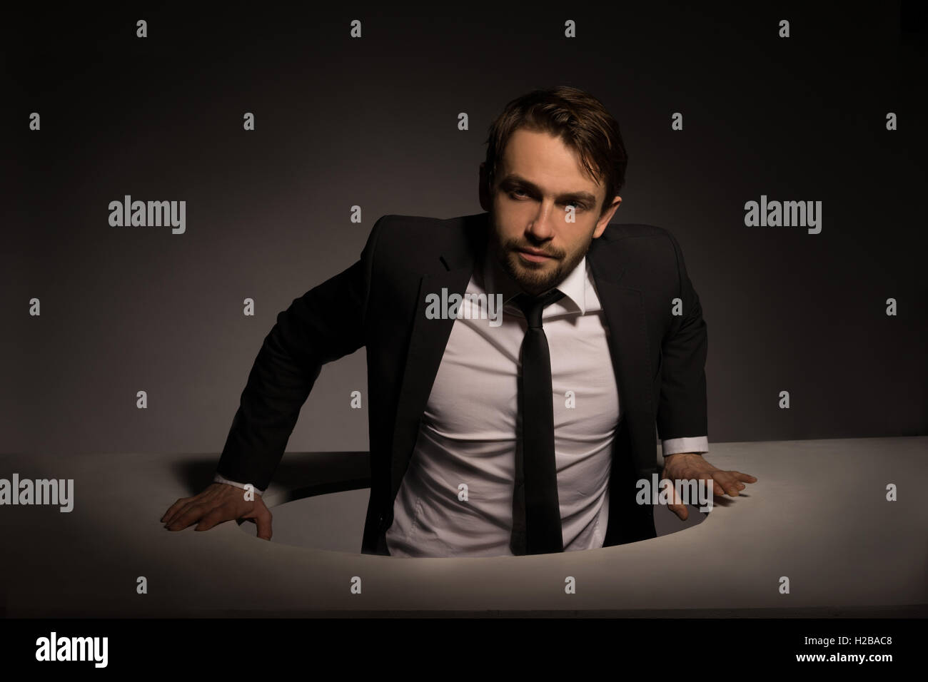 Man climbing out of hole hires stock photography and images Alamy