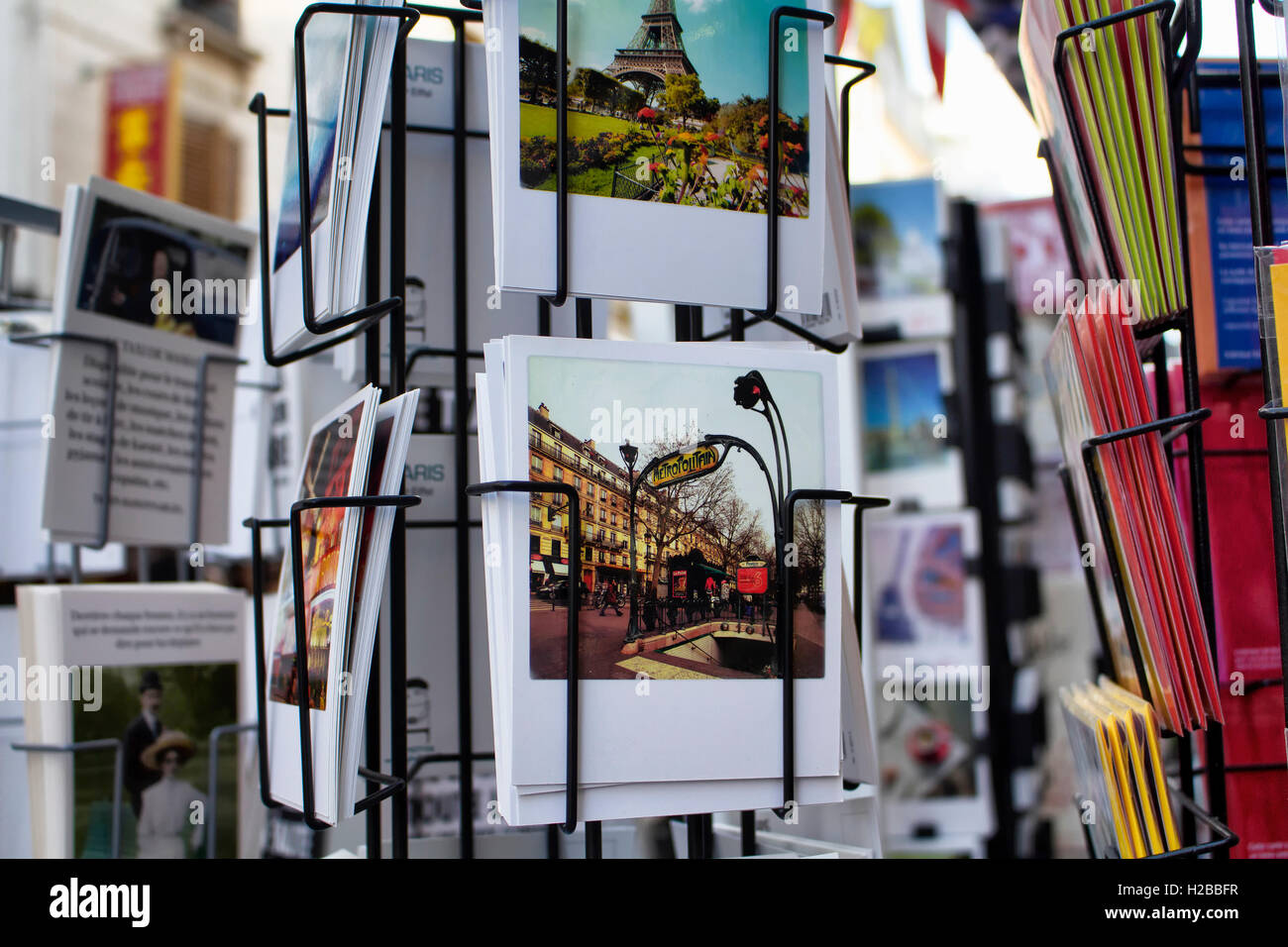 Close up view of French postcards on racks about subway sign on Rue Montorgueil street in Paris. Stock Photo