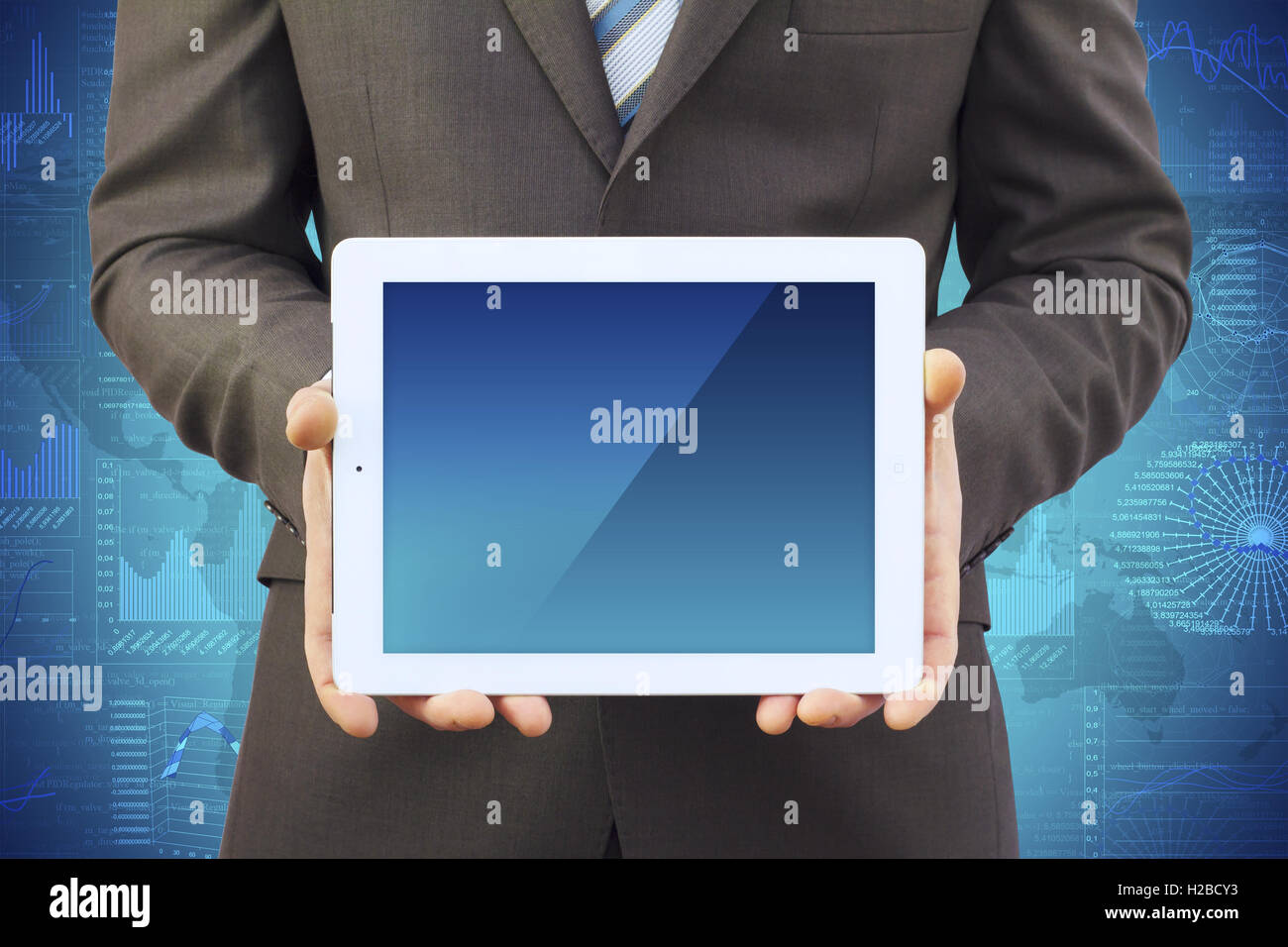 Businessman in a suit holding a tablet computer Stock Photo - Alamy