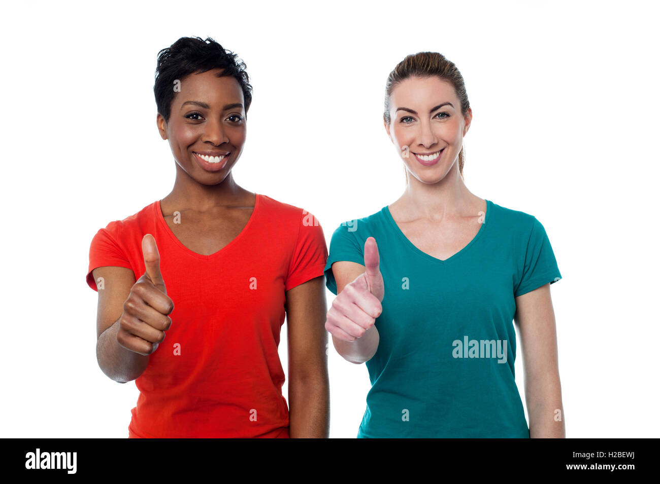 Two happy women with thumbs up Stock Photo - Alamy