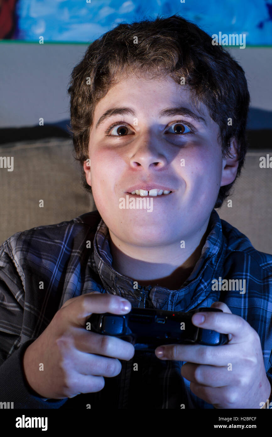 Entertainment. boy with joystick playing computer game at home Stock