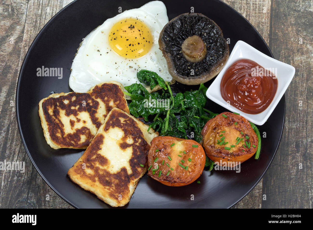 A fried vegetarian breakfast with halloumi cheese Stock Photo