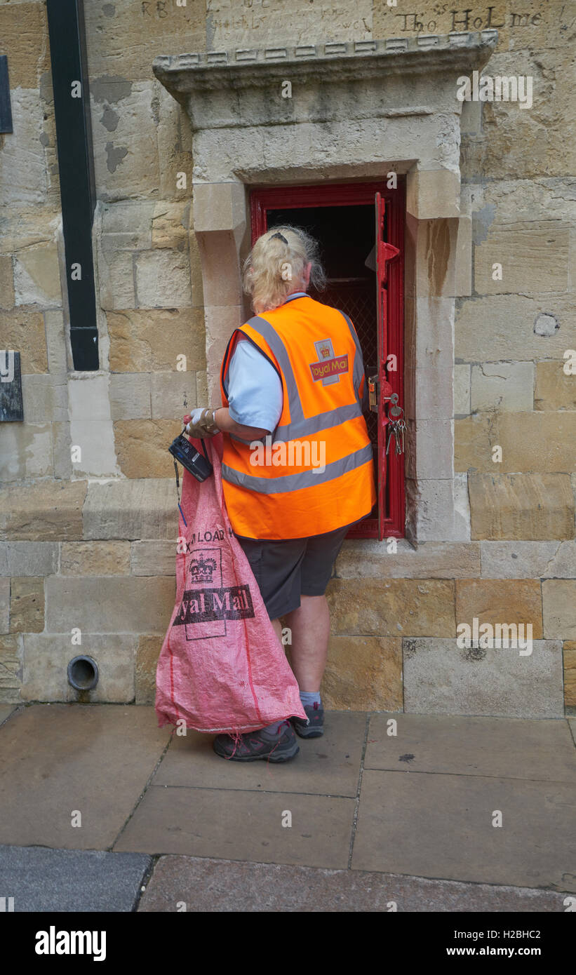Postwoman.  Collecting letters from postbox.  Royal Mail postman Stock Photo