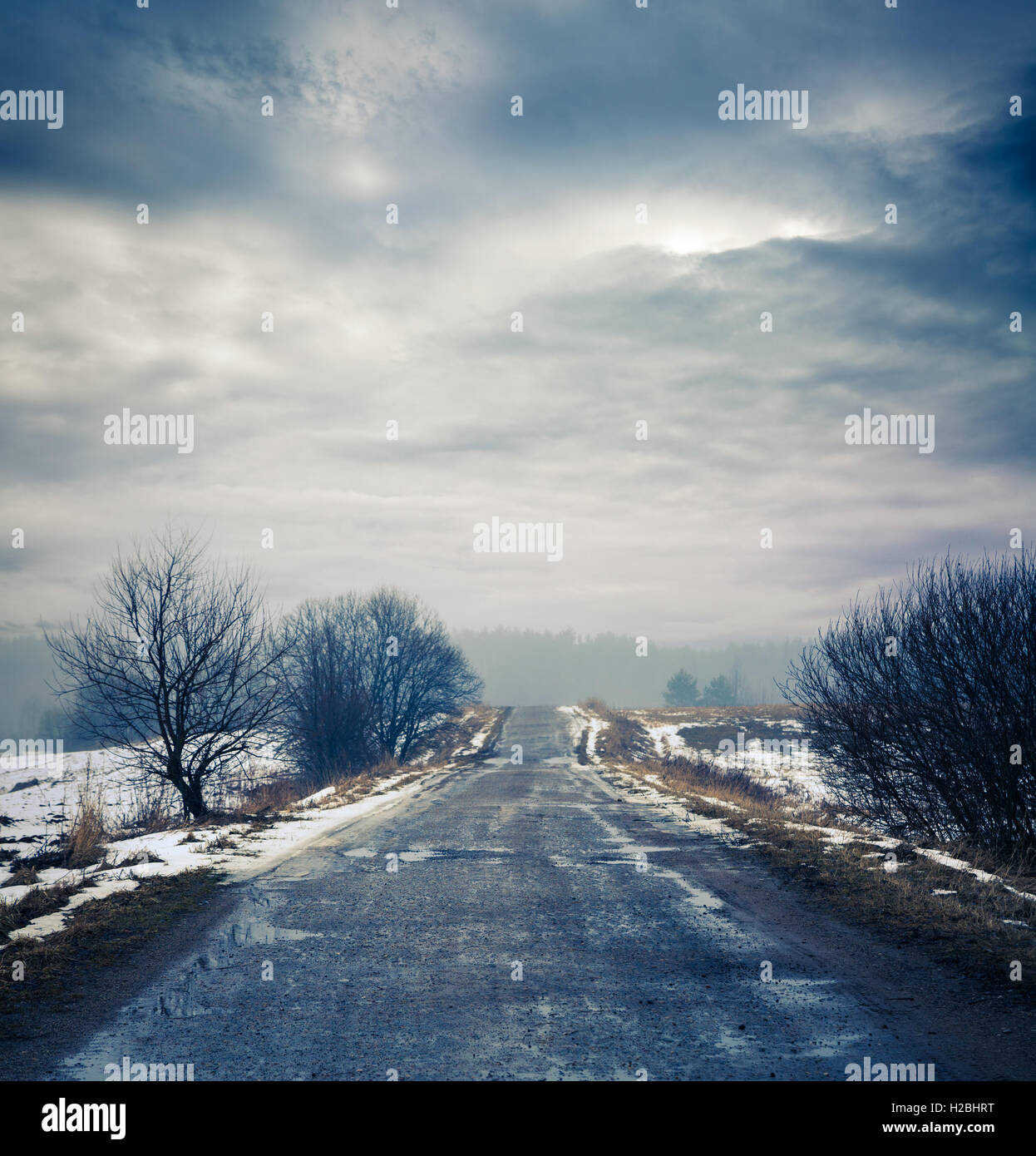 Winter Landscape with Dirty Road and Moody Sky Stock Photo - Alamy